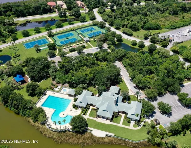 an aerial view of residential houses with outdoor space and street view