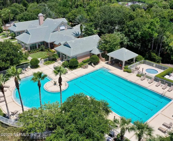an aerial view of a house with garden space and street view