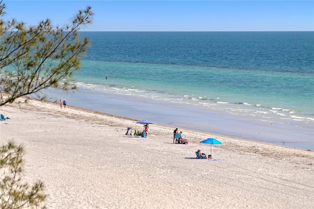 19730 Gulf Boulevard, Unit 400 Indian Rocks Beach, FL 33785 - Photo 19 of 90 a white bench sitting in the middle of a field