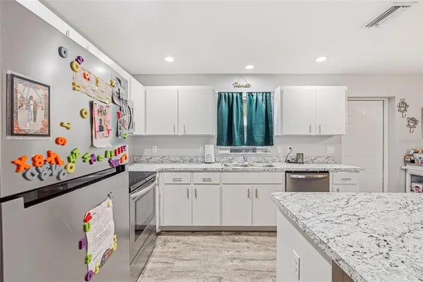 a kitchen with a sink stove and cabinets