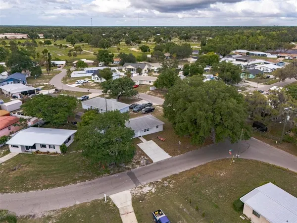 an aerial view of residential houses with outdoor space and lake view