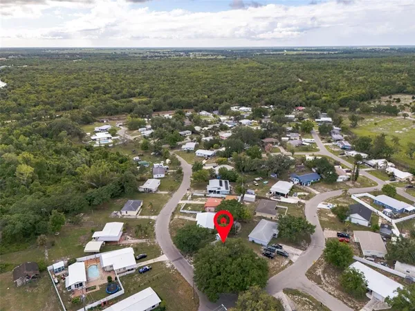 an aerial view of residential houses with outdoor space and ocean view