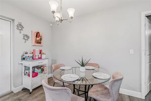 a view of a dining room with furniture wooden floor and a chandelier