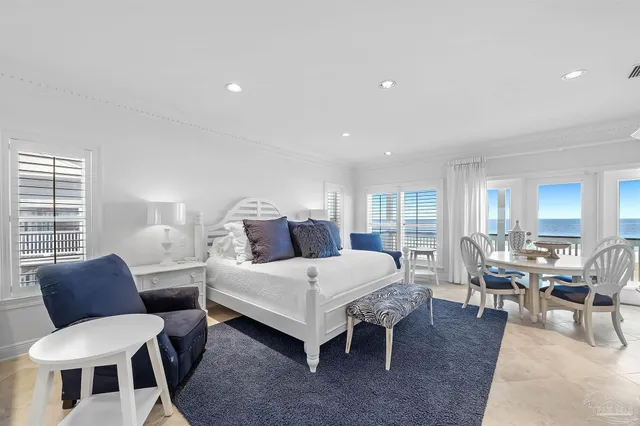 a bedroom with a bed a couch and dresser