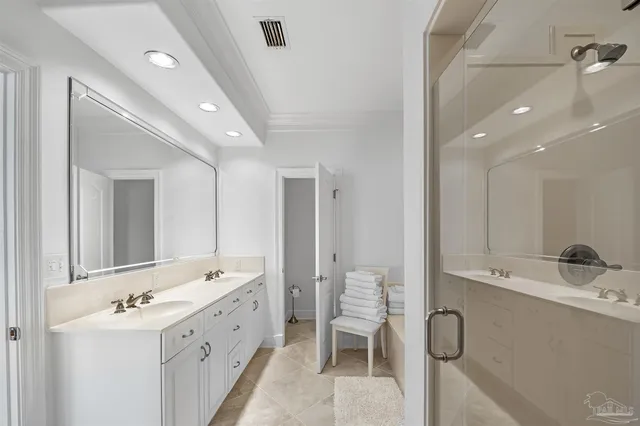 a bathroom with a double vanity sink a mirror and a bathtub