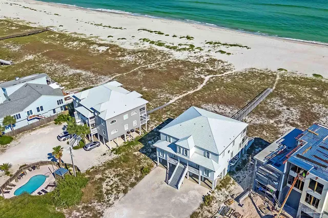 an aerial view of a house with a ocean view
