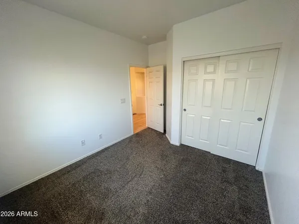 an empty room with closet area
