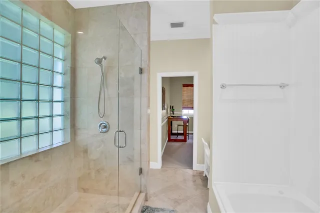 a bathroom with a shower and a sink