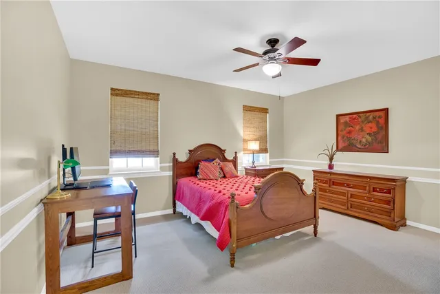 a bedroom with bed and a chandelier