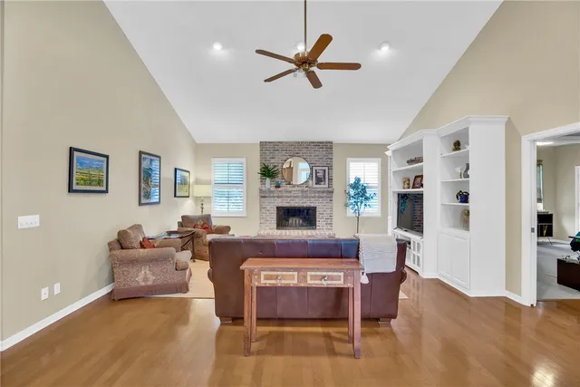 a living room with furniture a fireplace and a window