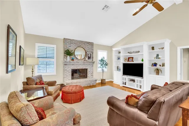 a living room with furniture flat screen tv and a fireplace