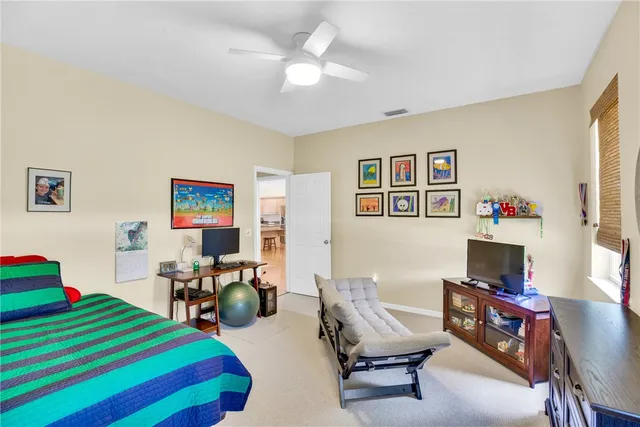 a bedroom with furniture and a workspace