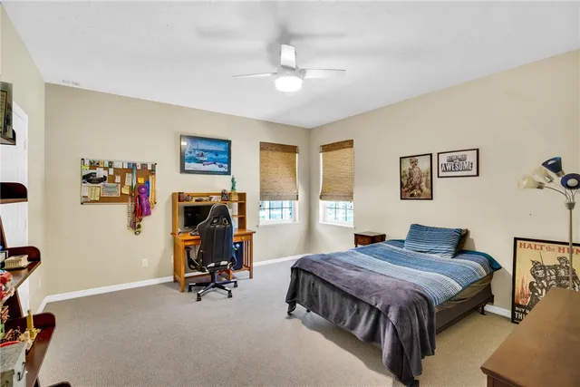 a bedroom with a bed a couch and a window