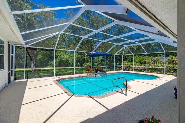 a view of a backyard with a swimming pool