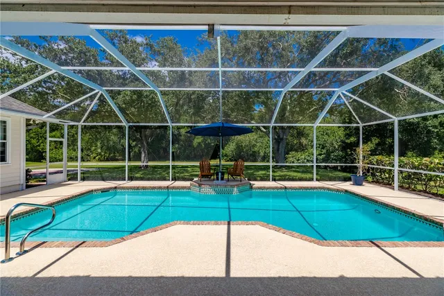 a view of a backyard with a swimming pool
