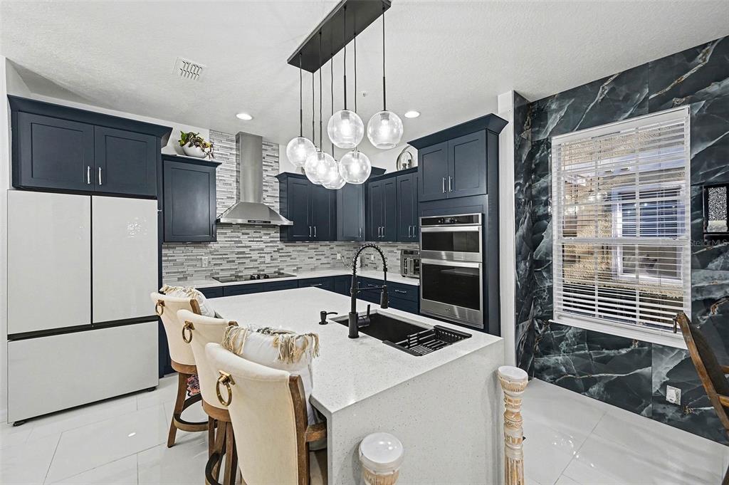 3565 Clay Brick Road Harmony, FL 34773 - Photo 12 of 37 a kitchen with a table chairs and refrigerator