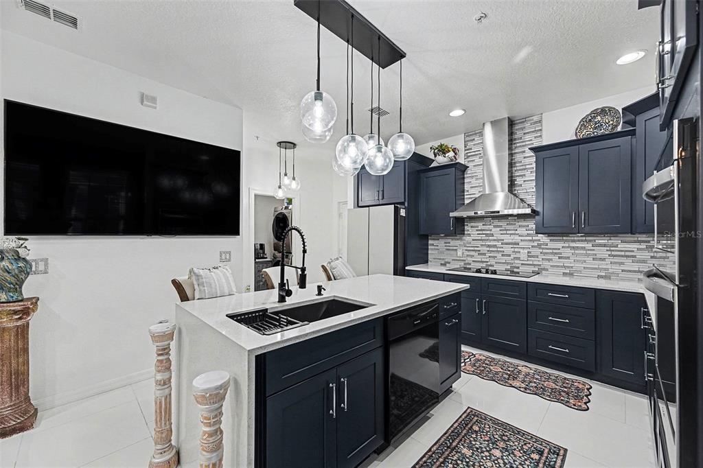 3565 Clay Brick Road Harmony, FL 34773 - Photo 13 of 37 a kitchen with a sink and a stove top oven with wooden floor
