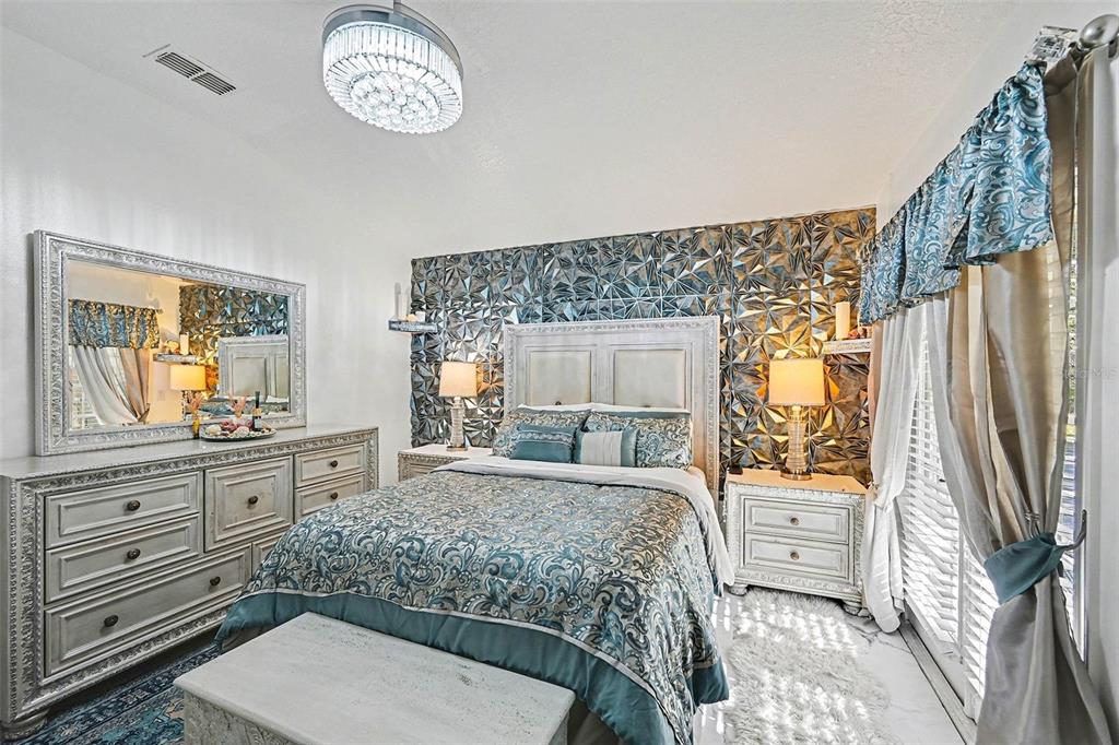 3565 Clay Brick Road Harmony, FL 34773 - Photo 15 of 37 a bedroom with a bed and a dresser in it