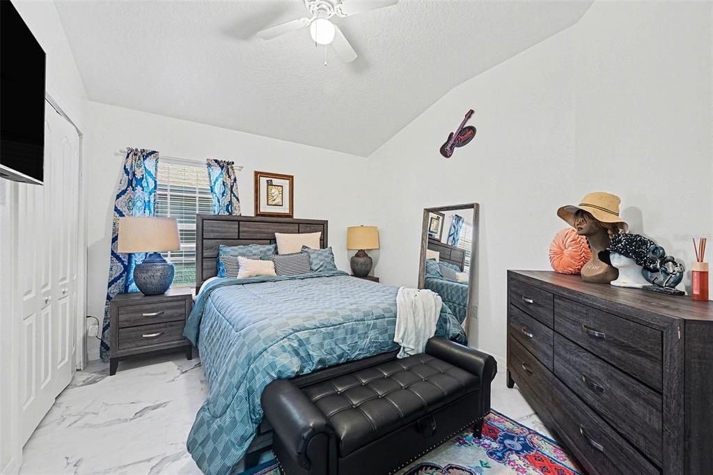 3565 Clay Brick Road Harmony, FL 34773 - Photo 19 of 37 a bedroom with a bed and dresser