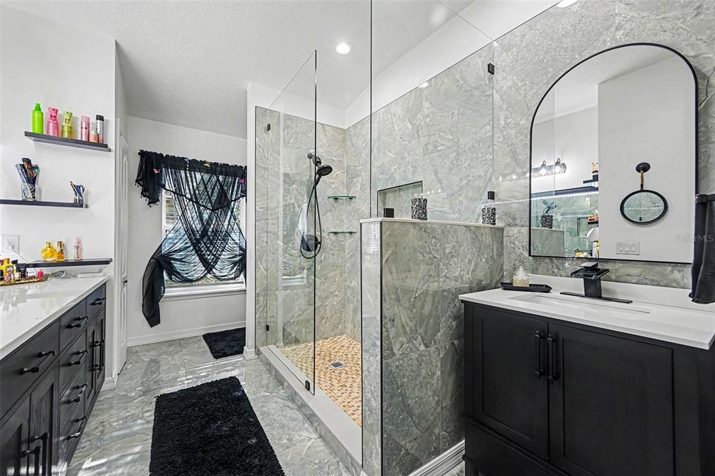 3565 Clay Brick Road Harmony, FL 34773 - Photo 20 of 37 a bathroom with a double vanity sink mirror and shower