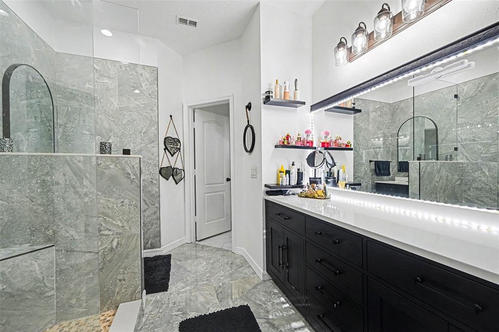 3565 Clay Brick Road Harmony, FL 34773 - Photo 22 of 37 a bathroom with a double vanity sink mirror and shower