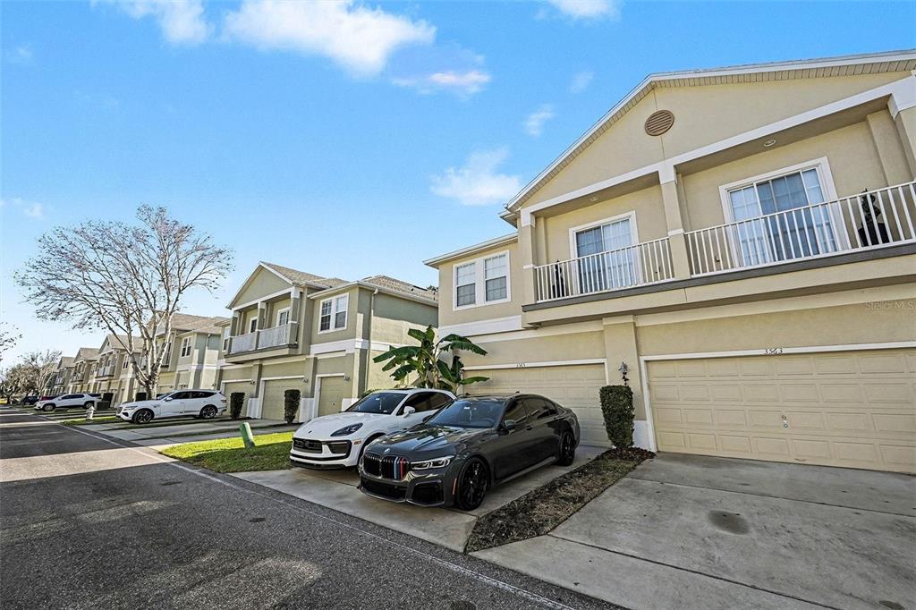 3565 Clay Brick Road Harmony, FL 34773 - Photo 4 of 37 a car parked in front of a white house