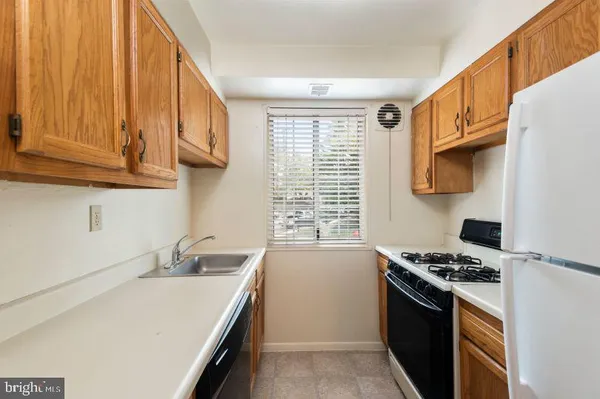 a kitchen with stainless steel appliances a sink a stove and a refrigerator