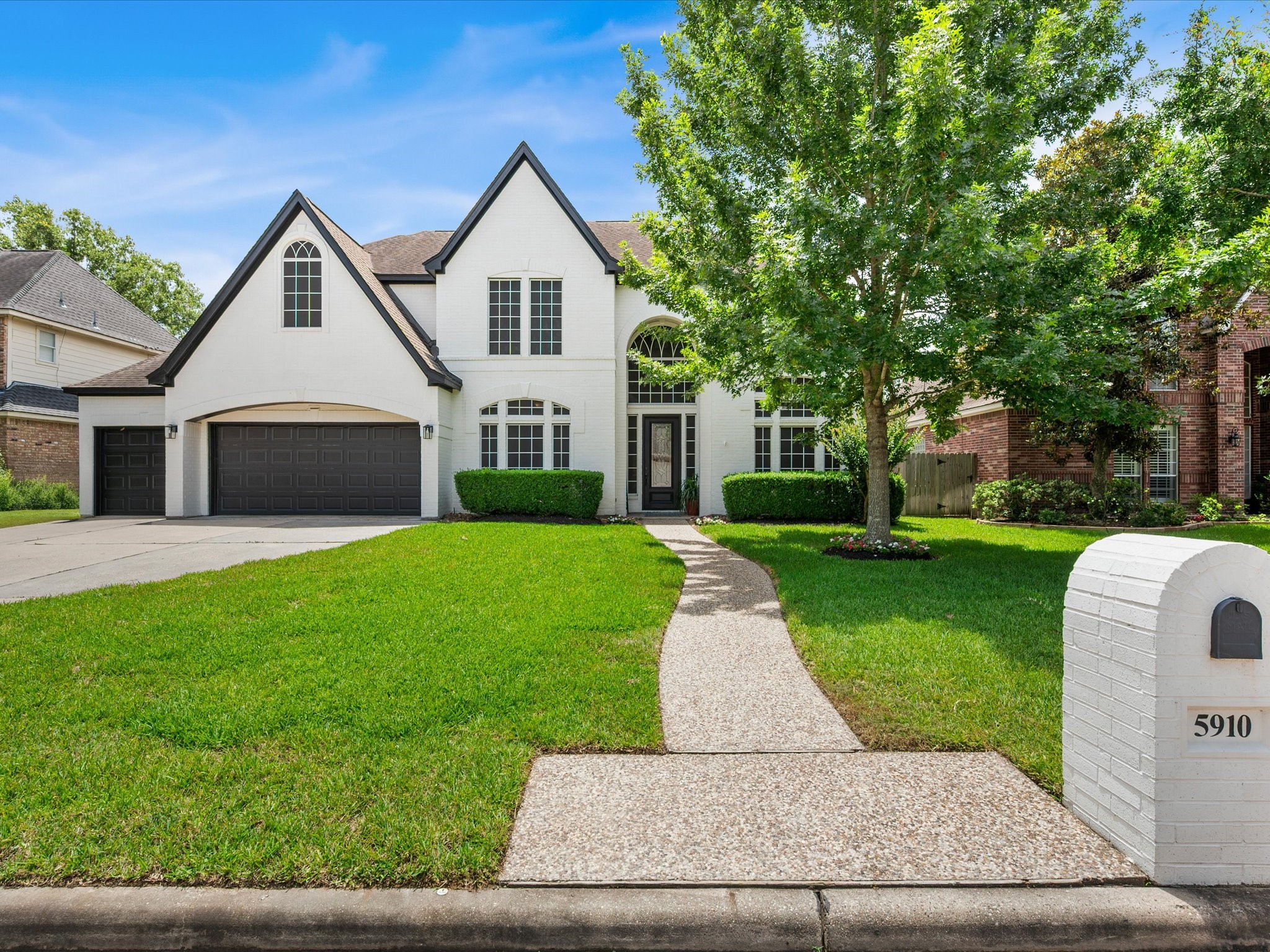 5910 Center Ct Drive Spring, TX 77379 - Photo 3 of 50 Fresh exterior paint, refreshed landscaping, and carefully curated improvements showcase the extensive renovation that has transformed this home inside and out.