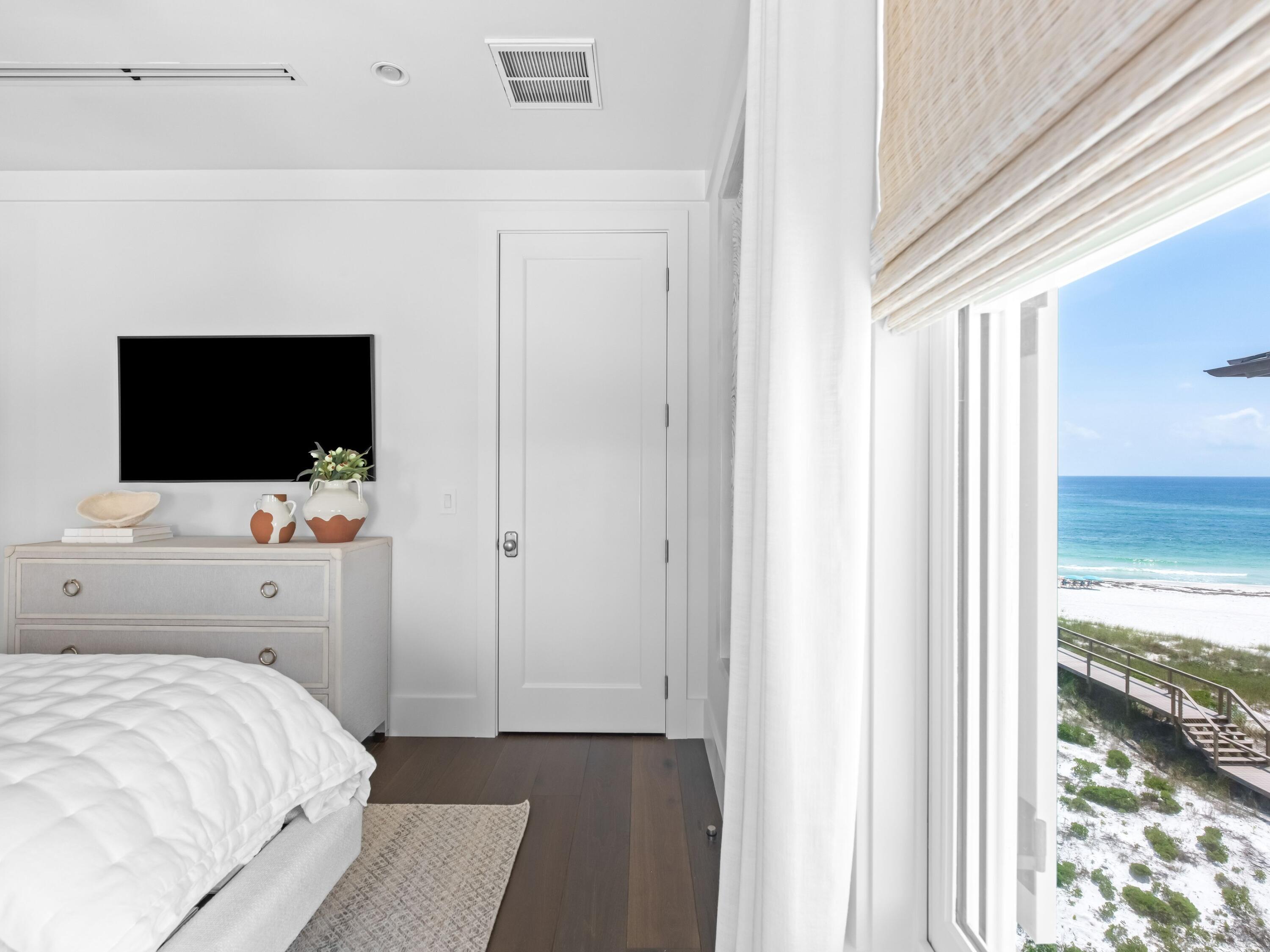 40 Lupin Bch Drive Inlet Beach, FL 32461 - Photo 30 of 35 a bedroom with a bed and a flat tv screen in it