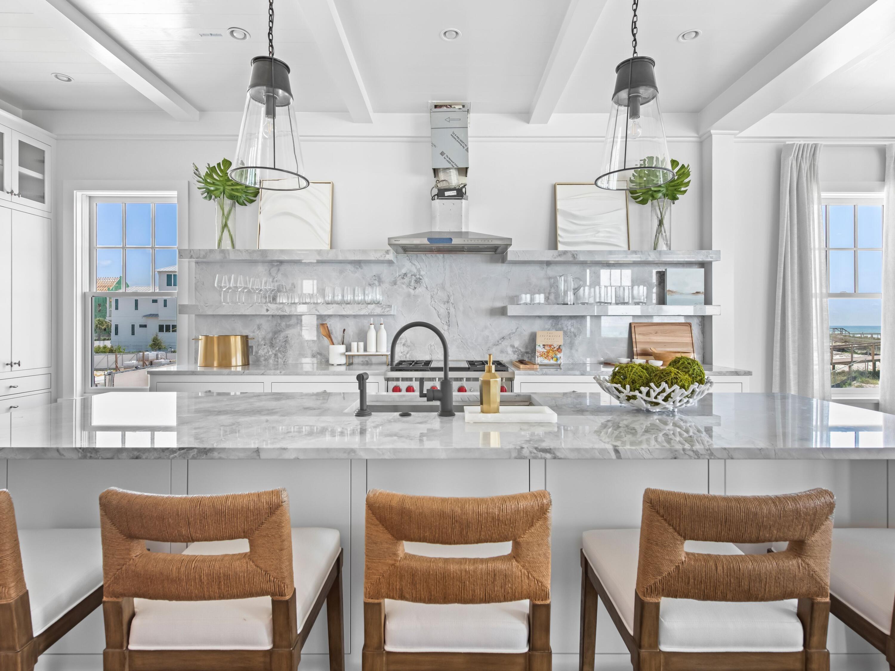 40 Lupin Bch Drive Inlet Beach, FL 32461 - Photo 6 of 35 a kitchen with stainless steel appliances granite countertop a sink and a dining table with chairs
