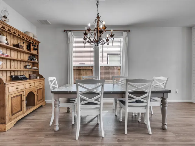 a view of a dining room with furniture and chandelier