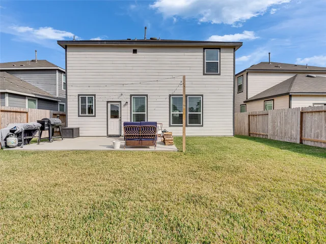 a house view with swimming pool in front of it