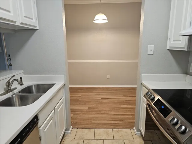 a kitchen with a sink and a stove top oven