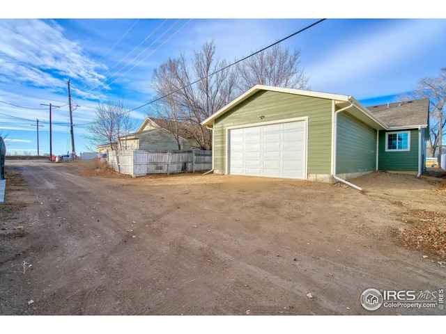 a view of a house with a yard and garage