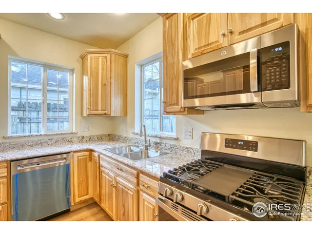 a kitchen with a stove a sink and a microwave