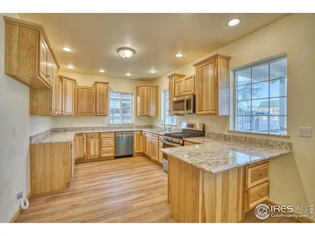 a kitchen with a stove a sink and a refrigerator