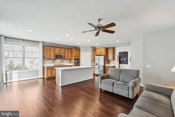 a living room with furniture and kitchen view