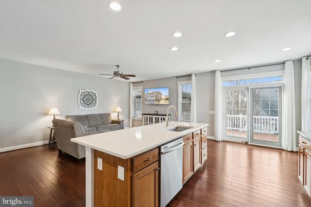a view of a kitchen with a sink and wooden floor