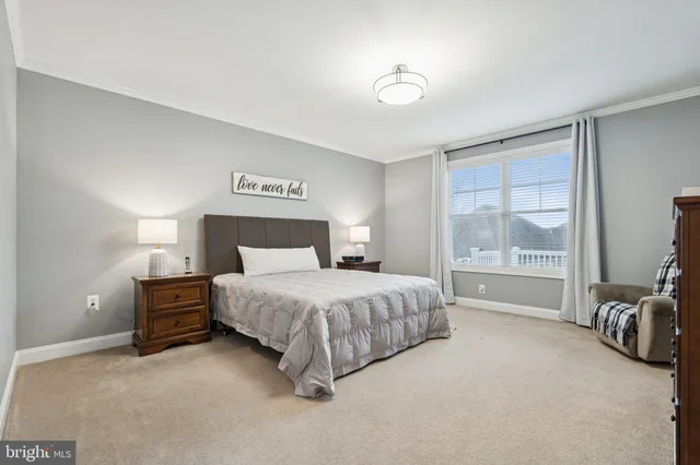 a spacious bedroom with a bed and a large window