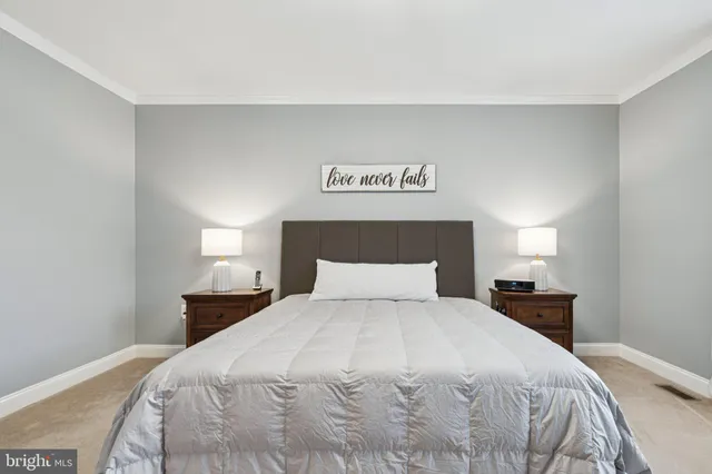 a bedroom with a bed and a night stand