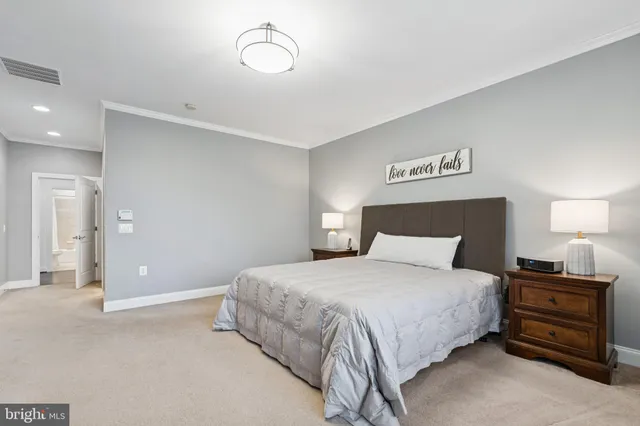 a bedroom with a bed and a night stand