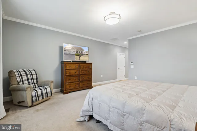 a bedroom with a bed and dresser