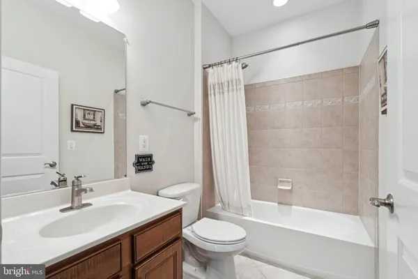 a bathroom with a sink toilet tub and shower