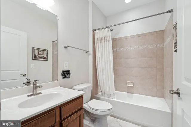 a bathroom with a sink toilet tub and shower