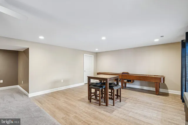 a view of a room with furniture and wooden floor
