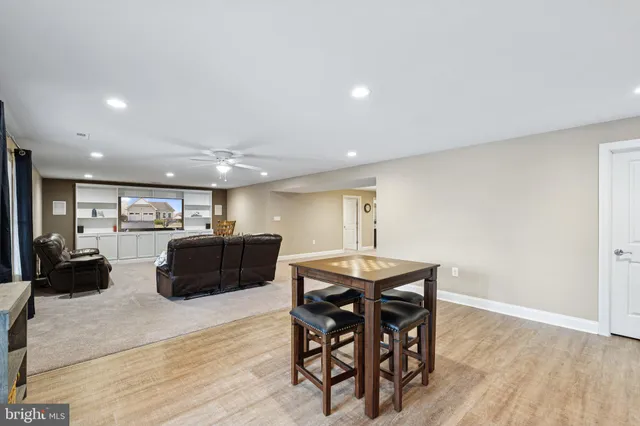 a living room with a baby crib furniture and a potted plant
