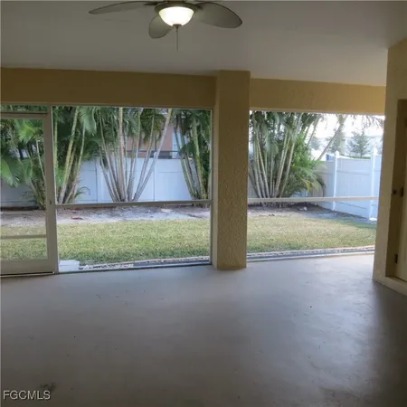 a view of a room with a big yard and potted plants