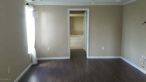 an empty room with wooden floor and closet