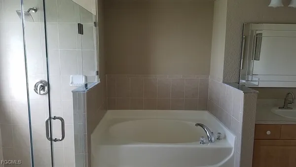 a bath tub sitting next to a shower