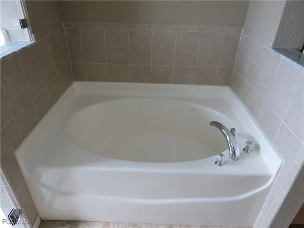 a white bath tub sitting in a bathroom